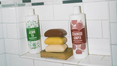shower with body wash and 3 bar soaps stacked on soap dish
